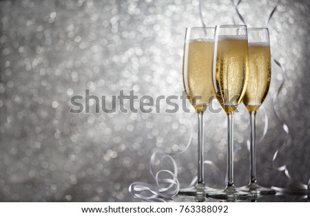 Picture of three glasses with wine on gray background.