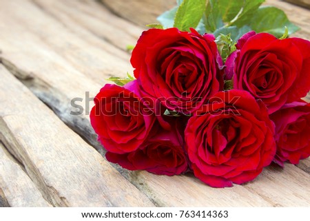 Red roses on old wood background with copy space,Valentine's Day Concept.