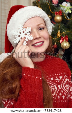 Girl dressed as santa in christmas decoration at home. New year eve and winter holiday concept.