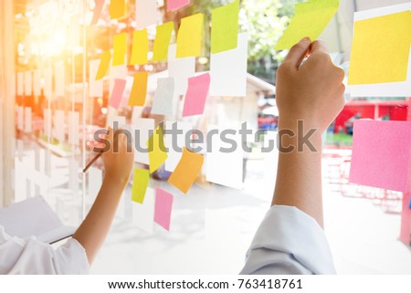 business people post it notes in glass wall at meeting room Royalty-Free Stock Photo #763418761