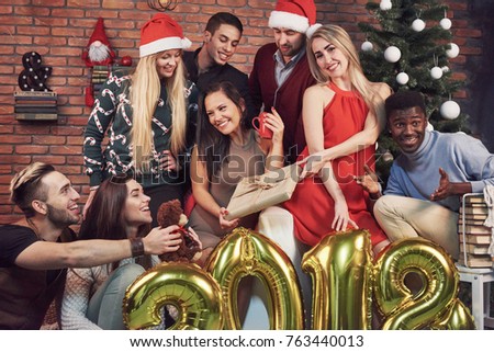 Photo with friends. Group of cheerful young people make a festive photo near the Christmas tree. Happy New 2018 Year to you! Concept of entertainment and lifestyle.