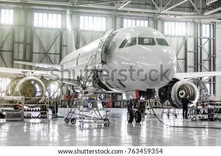 Passenger aircraft on maintenance of engine and fuselage repair in airport hangar Royalty-Free Stock Photo #763459354