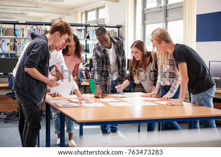 Group Of College Students Collaborating On Project In Library Royalty-Free Stock Photo #763473283