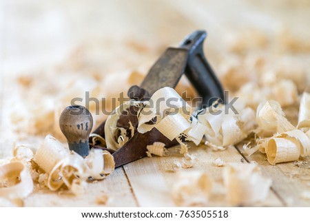 carpenter's board on a board surrounded by shavings blurred background small depth of field