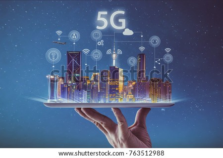 Waiter hand holding an empty digital tablet with smart city and 5G network wireless systems and internet of things . Royalty-Free Stock Photo #763512988