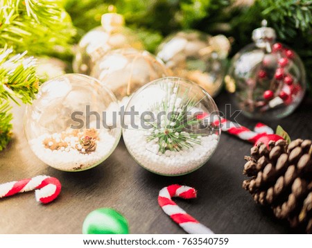 close up Christmas and happy New Year concept with Christmas ball and Christmas decorations on black wooden table background with morning sunlight