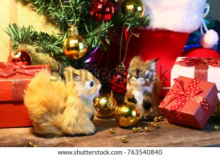 Two Squirrels and gift decorate under christmas tree for celebration party. 