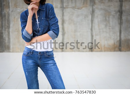 Closeup woman casual outfits standing cross one's arm and wear jeans denims