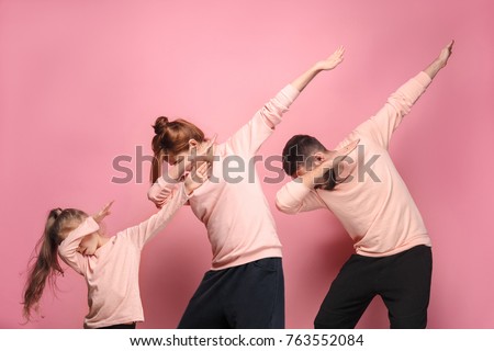 The dancing young family on pink Royalty-Free Stock Photo #763552084