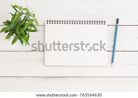 Flat lay photo of blank whtie notebook on whtie table