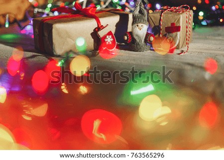 Blurred picture of a little elf standing between brown present boxes
