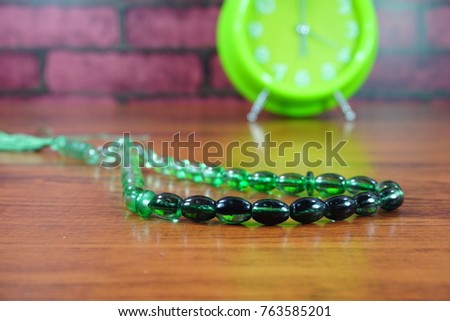 String of beads is used for Muslims in their tasbih (in English is the repetitive utterances glorification of Allah). Conceptual isolated and selective focused photo with the brick background