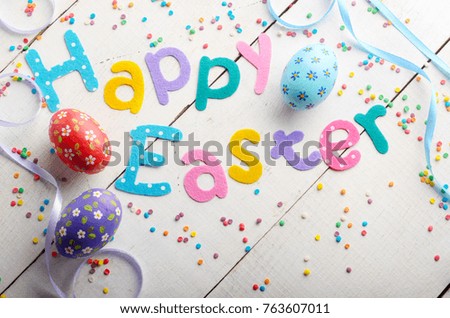 Happy Easter phrase made of fabric letters on white table