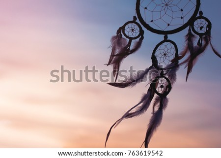 Silhouette of dream catcher in the twilight time, pastel toned, selective focus and blurred background