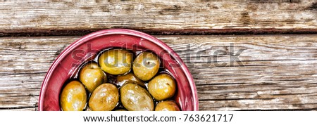 Olives on a wooden background. View from above