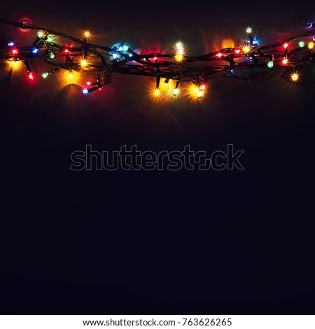 Luminous Christmas gerland on a dark background. Copy space.Christmas, New Year's background.Christmas card
