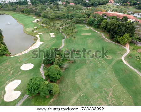 Aerial picture of a golf course and country club before rain.