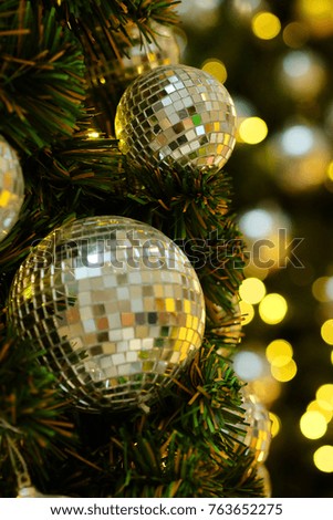 Mirror balls and light bokeh on artificial tree with space for write wording, decorate in a department store in seasons' greeting such as Christmas and New Year festival for family, friends and lovers
