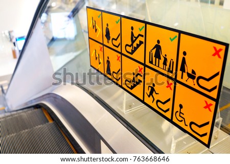 Signs on an escalator, warning signs, the escalator at the shopping mall