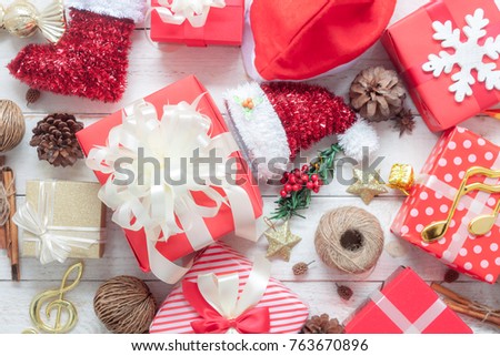 Table top view image of decorations Merry Christmas & Happy New Year background concept.Many beautiful gift boxes and ornaments decor seasonal on modern rustic white wooden at home office desk studio.