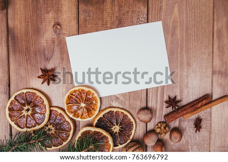 Christmas greeting card and food decor on wooden table with fir tree. Top view with copy space