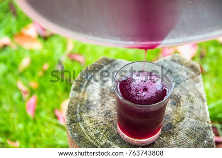 Fermented natural fruit juice, pouring into a glass
