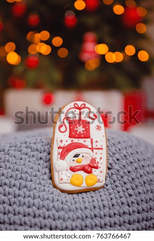new year Gingerbread on glowing lights of a Christmas tree. Concept of sweets and gifts