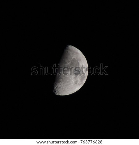 Half Moon with craters as seen through a photographic 180mm objective, concept of astronomy and telescope amateur backyard night sky observation