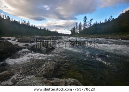 The mountain river Haramatalow in the Polar Urals. Summer water northern landscape.