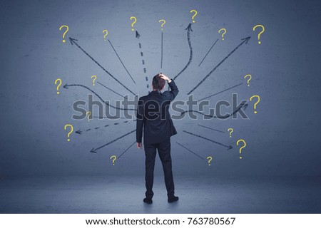 Businessman standing in front lines and question mark signs concept on background