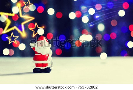 Santa claus standing on white floor with beautiful bokeh lights for christmas day festive background