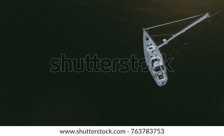 aerial shot of a sailing boat in the ocean