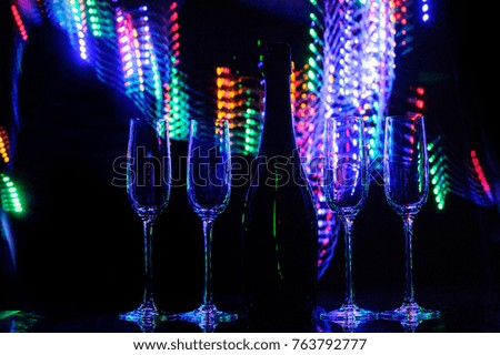 Glasses of champagne on bright background with bokeh effect. Cheers
