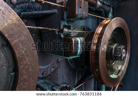 Copper round rollers for rolling wire. Fragment Wire drawing equipment. Abstract industrial background. Royalty-Free Stock Photo #763831186