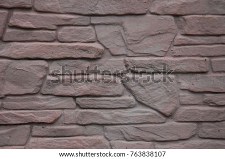 Modern stone fence with decorative cracks