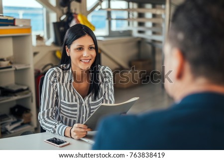 Woman consultant talking with client in office. Royalty-Free Stock Photo #763838419