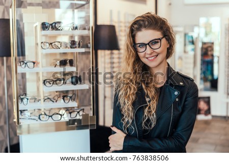 Portrait of smiling woman in optical store. Royalty-Free Stock Photo #763838506