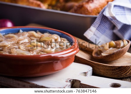 Onion gravy, sauce served with sausages in Yorkshire pudding batter, traditional British dish  