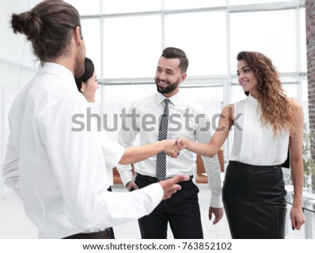 business women greet each other with a handshake