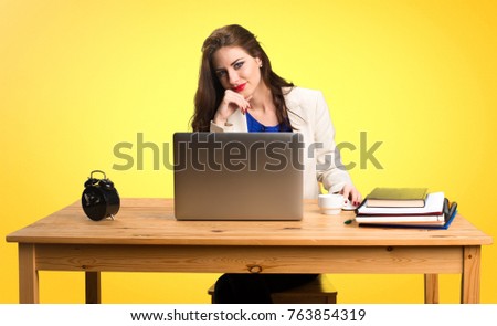 Business woman working with her laptop on colorful background
