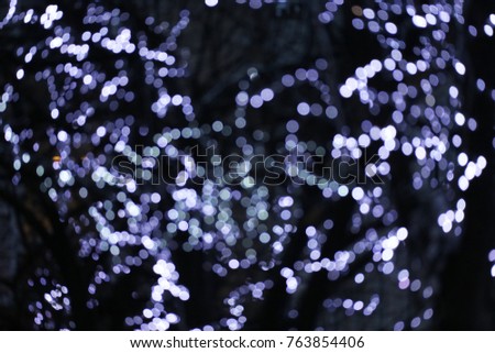 Blur blue and grey color bokeh of decorative light with the dark background 