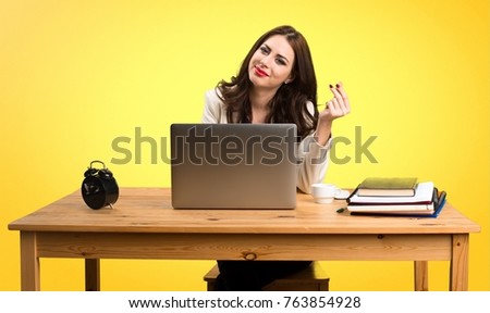 Business woman working with her laptop and making money gesture on colorful background