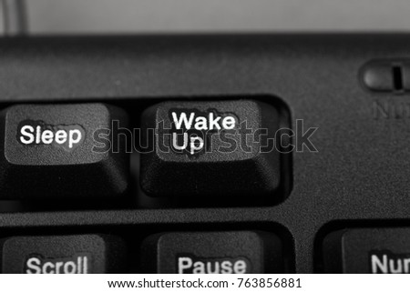 button, wake up and sleep on the keyboard, conceptual photo, close-up
