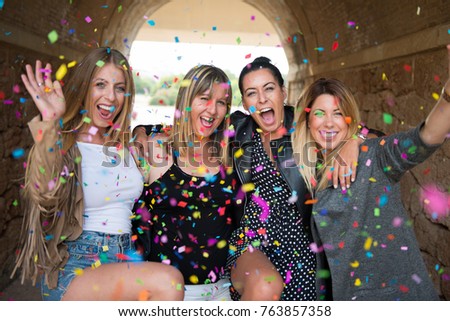 Group of young friends with confetti