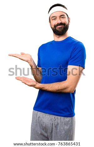 Funny sportsman presenting something on isolated white background