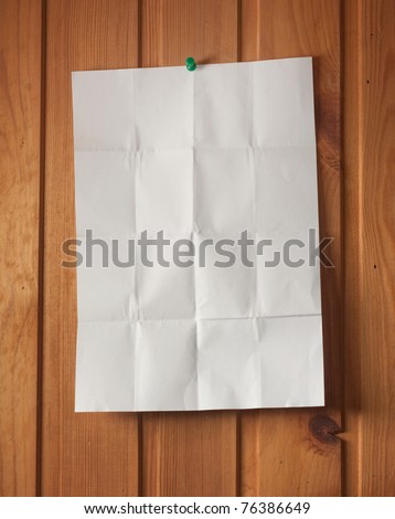 Wrinkled paper on wood wall