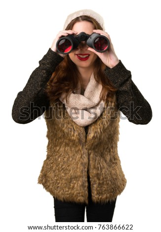 Girl with winter clothes with binoculars