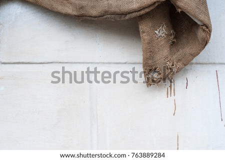 old burlap on white background. old natural color burlap. Bag of burlap hanging on a white wall background