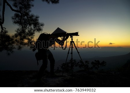 Photographer silhouette are take a photo on the mountain of national park Phu Kradueng Loei Thailand.