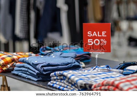 sale 50% off mock up advertise display frame setting over the clothes line in the shopping department store for shopping, business fashion and advertisement concept